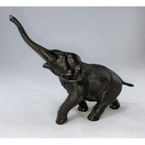 176B - A Japanese Meiji period bronze elephant with outstretched trunk, rectangular seal mark to underbelly... 