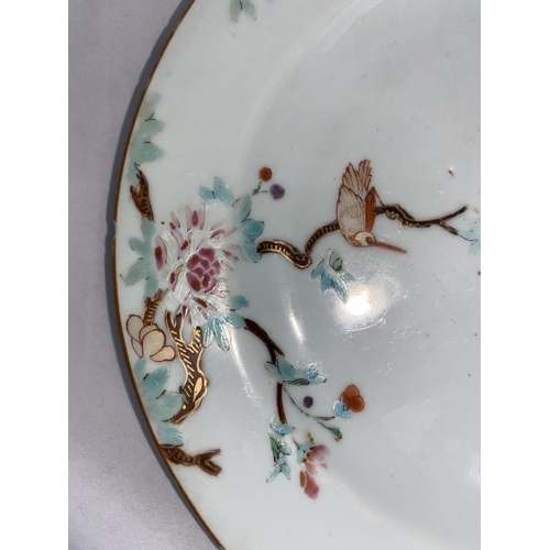 197 - A Chinese porcelain plate with polychrome floral decoration, diamter 23cm; another similar plate 23c... 
