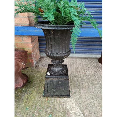 148 - A cast iron garden urn on square section pedestal
