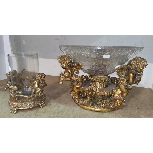 65 - A gilded ornate vase stand decorated with cherubs, etc., with glass bowl; a similar vase
