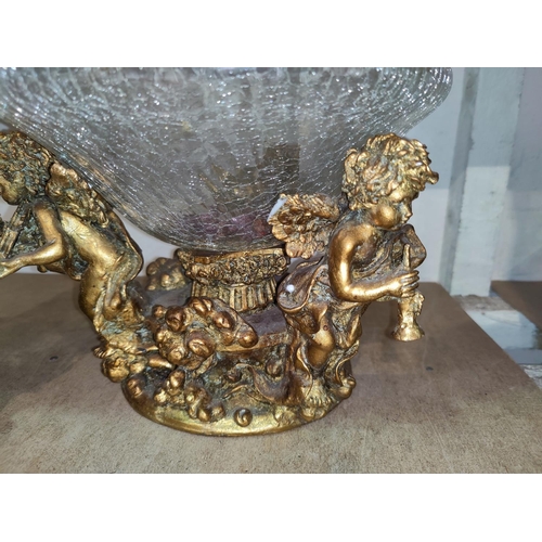 65 - A gilded ornate vase stand decorated with cherubs, etc., with glass bowl; a similar vase