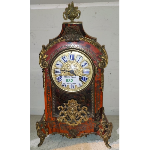 532 - A 19th century French mantel clock in arch top boulle case with ornate ormolu finial, feet and mount... 