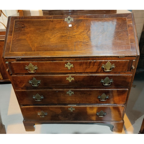 561 - A Georgian crosshanded and inlaid fall front bureau with graduating drawers under, on bracket feet, ... 
