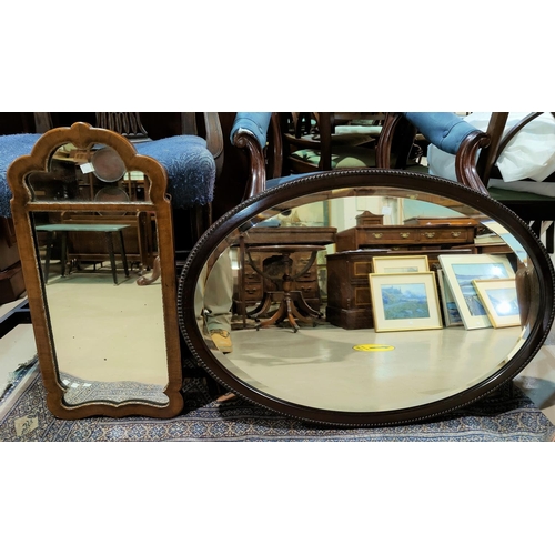 571 - A 19th century wall mirror in mahogany and parcel gilt frame; a similar oval mirror