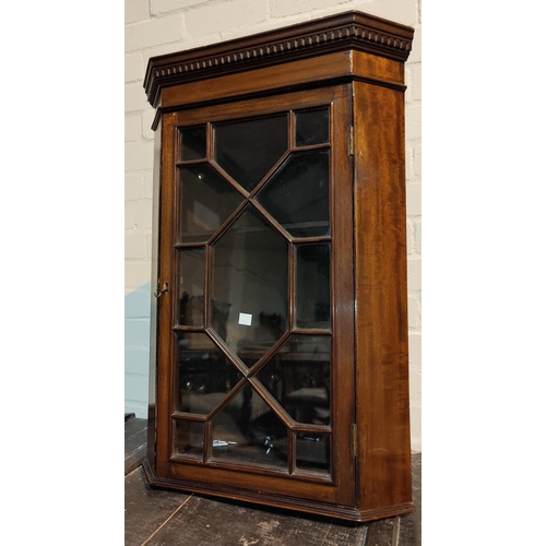 574 - A 19th century small corner cupboard with astragal glazing