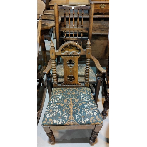 687 - A 19th century elm rocking chair with spindle back and rush seat; an oak gothic style hall chair on ... 