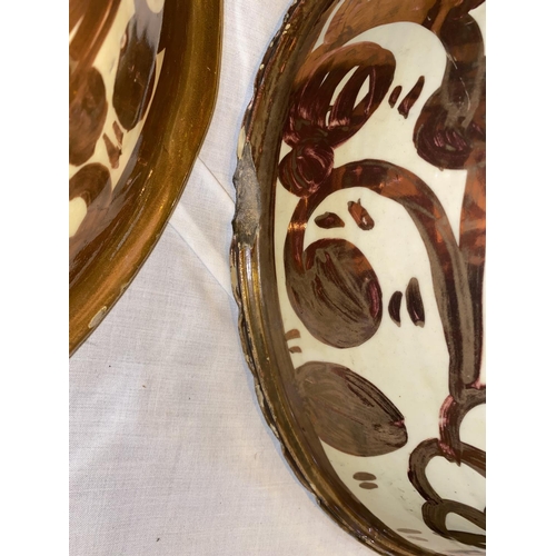 177 - An 18th/19th century pair of large Hispano-Moresque bowls of tapering form, tin glazed with copper l... 