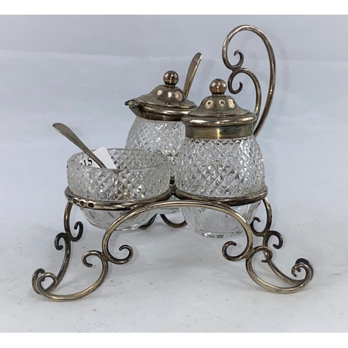 394 - A silver and cut glass cruet stand of scalloped openwork form, with matched spoons, maker L&S, Birmi... 