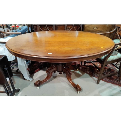 555 - A Victorian mahogany looe table with oval tilt top on central collared column and 4 splay feet with ... 
