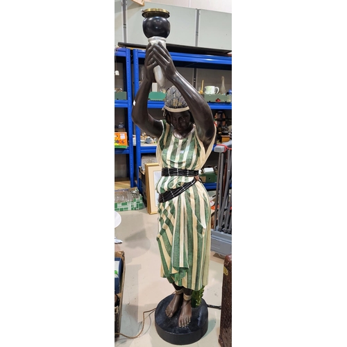 668 - A Georgian style half size torchère in the form of a female blackamoor in green stripe dress