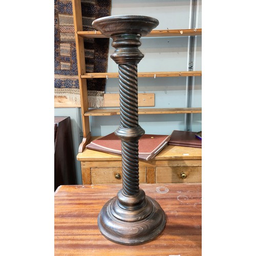 680 - A Georgian style mahogany torchère on turned column and 3 splay feet; a similar smaller torchère