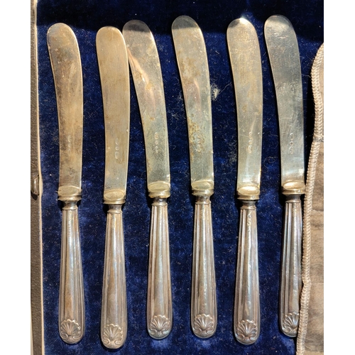 393 - A child's silver fork and spoon set, cased; a set of silver cased knives; a quantity of dessert cutl... 