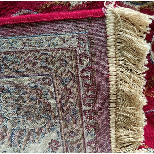 482 - A Kashmir rug with floral medallion pattern on red ground, 240 x 160 cm