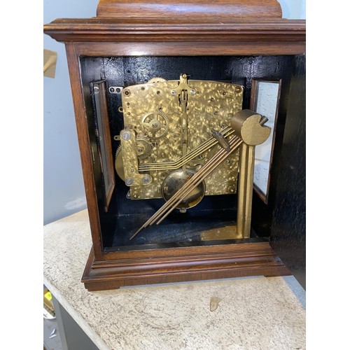 493 - A reproduction 18th century style bracket clock in walnut caddy top case, brass dial and chiming mov... 