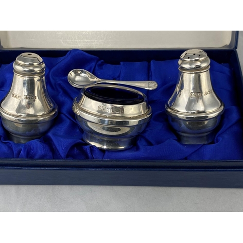 267 - A modern silver three piece cruet set, boxed