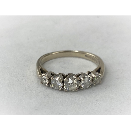 293 - An 18ct white metal 5 diamond set dress ring with larger central diamond with two graduating diamond... 