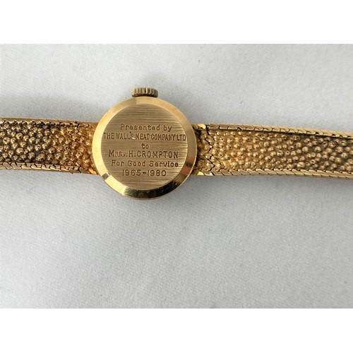 295 - A 9ct gold Garrard ladies dress watch with bark effect strap,  baton marks in Garrard box, gross wei... 