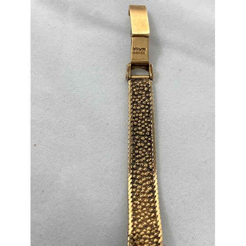 295 - A 9ct gold Garrard ladies dress watch with bark effect strap,  baton marks in Garrard box, gross wei... 