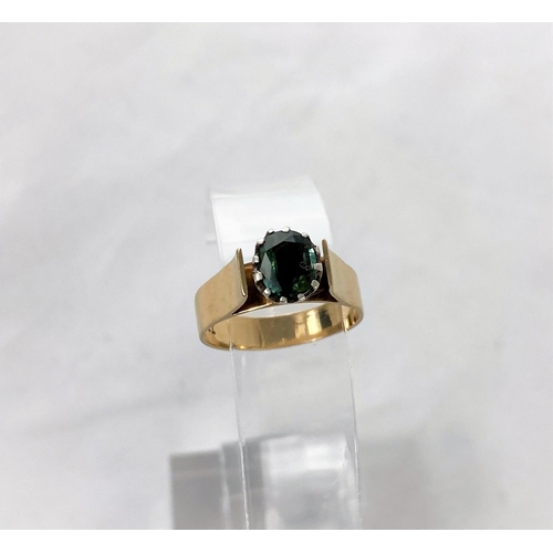 304 - A 1970's yellow metal dress ring with wide shank and shoulders, set green topaz type stone, 9ct, 3.4... 