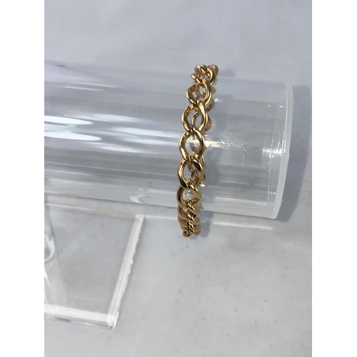 313 - A yellow metal bracelet formed from flatted curb links, stamped '9ct', 19.6 gm