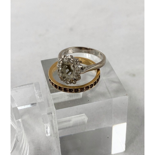 317 - A white metal and diamond ring stamped '18ct' size 'J' (central stone missing); a yellow metal etern... 