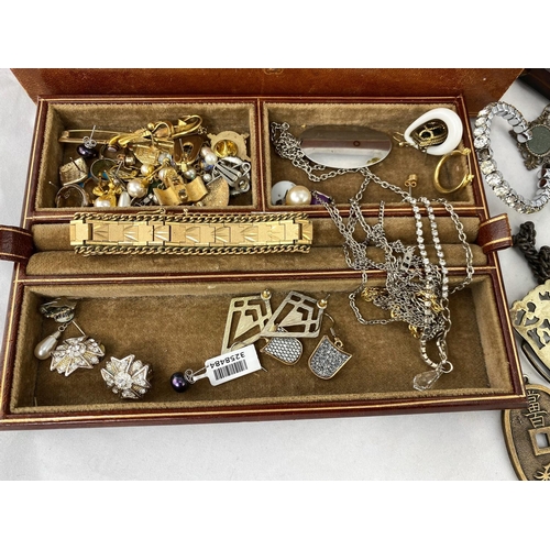 340 - A brown leather jewellery box with a selection of costume jewellery; Chinese coins; etc.