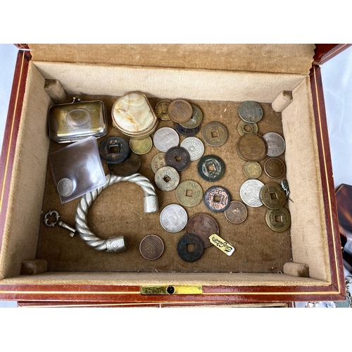 340 - A brown leather jewellery box with a selection of costume jewellery; Chinese coins; etc.