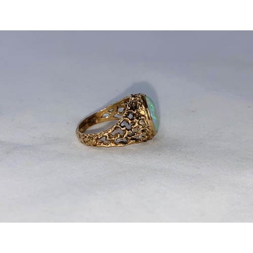 374 - A 1960's/70's modernist 9 carat hallmarked gold dress ring with naturalistic pierced shoulders, set ... 