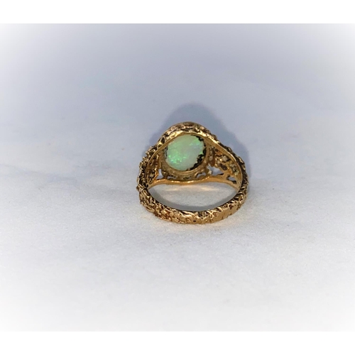 374 - A 1960's/70's modernist 9 carat hallmarked gold dress ring with naturalistic pierced shoulders, set ... 