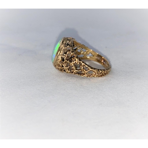 374 - A 1960's/70's modernist 9 carat hallmarked gold dress ring with naturalistic pierced shoulders, set ... 