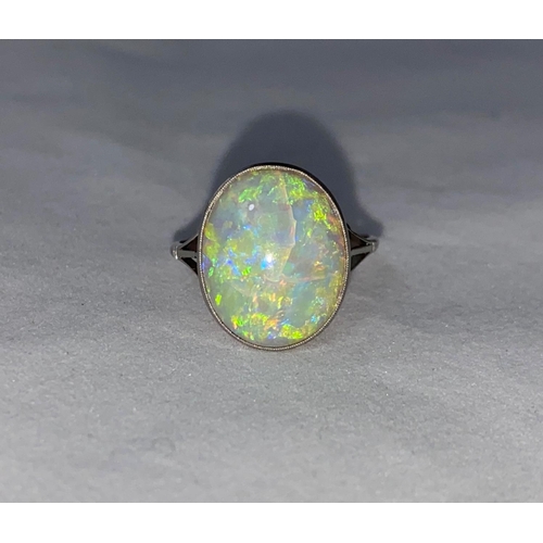 384 - A white metal dress ring set large opal coloured stone, stamped 'PLATINUM', length of stone 17 mm ap... 