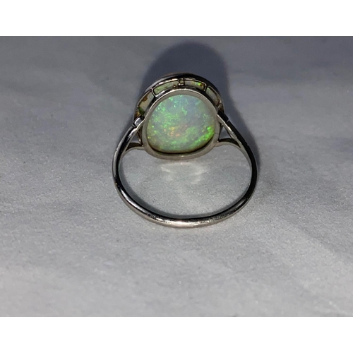 384 - A white metal dress ring set large opal coloured stone, stamped 'PLATINUM', length of stone 17 mm ap... 