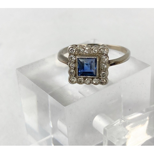 385 - A white metal square dress ring set central cushion cut sapphire surrounded by 16 diamonds, length o... 