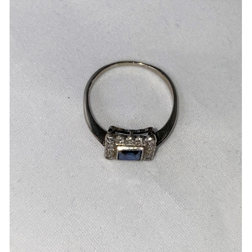 385 - A white metal square dress ring set central cushion cut sapphire surrounded by 16 diamonds, length o... 