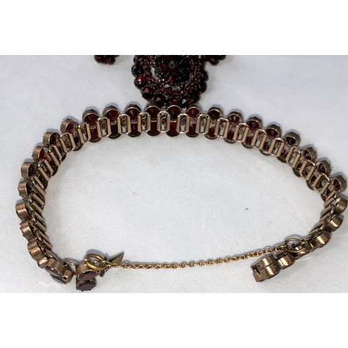 396 - A late Victorian/Edwardian suite of garnet jewellery:  double row bracelet, circular tiered brooch a... 