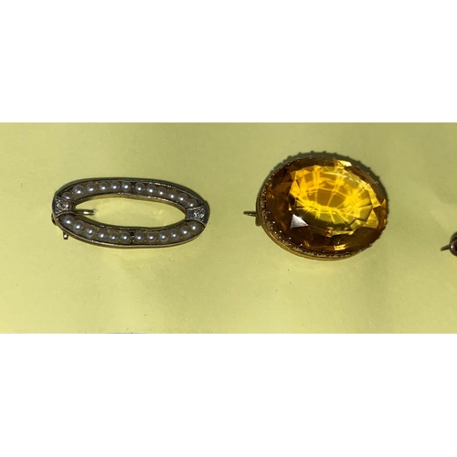 397 - A Victorian brooch set oval amber coloured faceted stone; another brooch set amber coloured rectangu... 