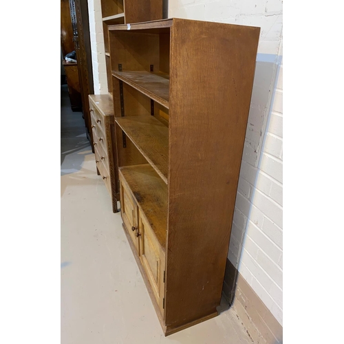 487 - An oak Arts & Crafts style bookcase with double cupboard to base, height 127cm x depth 28cm x length... 