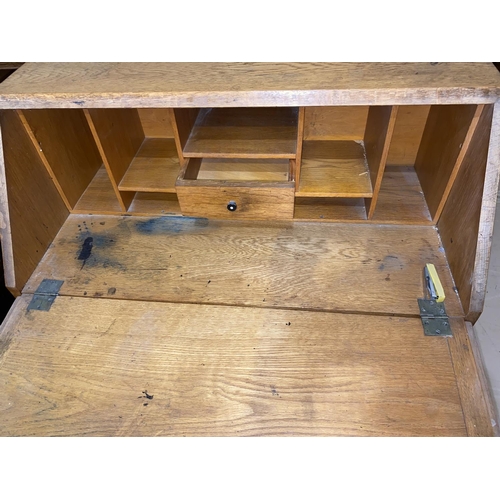 499 - A mid 20th century oak bureau with fall font and 3 drawers, width 76 cm