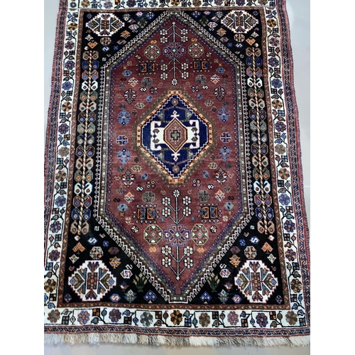 559 - A modern hand knotted Persian rug with brown ground, length 148 cm; a similar smaller rug