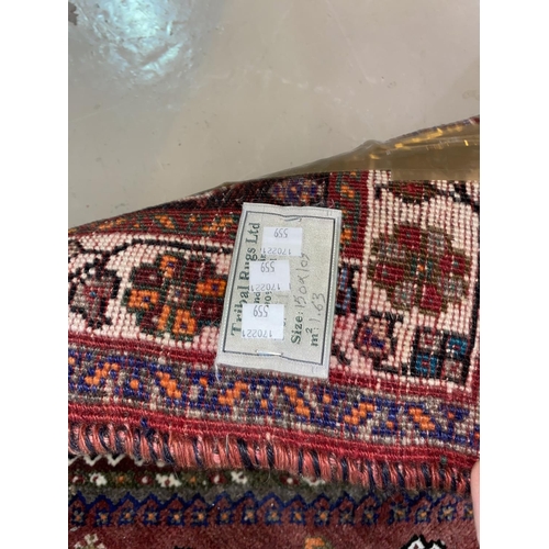 559 - A modern hand knotted Persian rug with brown ground, length 148 cm; a similar smaller rug