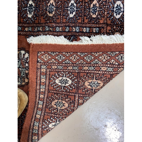 559 - A modern hand knotted Persian rug with brown ground, length 148 cm; a similar smaller rug