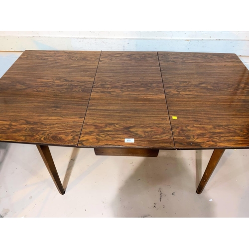 575 - A 1960's drop leaf dining table with rosewood effect laminate top