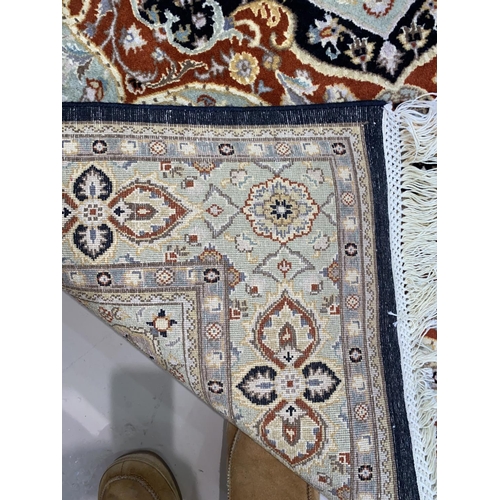 602 - A modern hand knotted Persian rug with floral pattern on a fawn / pale green ground, length 190 cm,