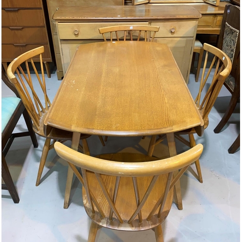 603 - A 1960's Ercol light elm dining suite comprising drop leaf circular table, 5 stick back chairs and s... 