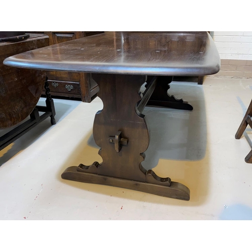 605 - An Ercol buffet sideboard; a refectory dining table with rectangular top