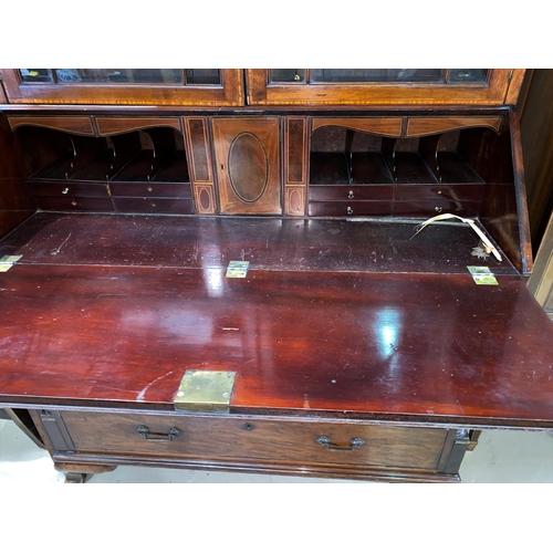 607 - A George III mahogany bureau with fall front enclosing central boxwood inlaid cupboard door flanked ... 