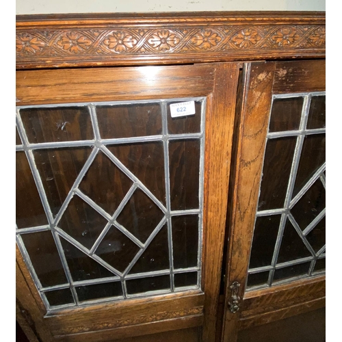 622 - A Jacobean style oak side cabinet enclosed by 2 part leaded glass doors