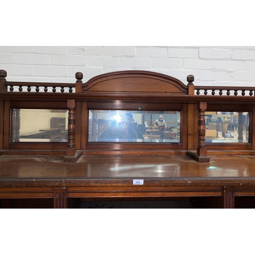 646 - An Edwardian large bookcase/side cabinet with low raised mirror back, 4 canted shelves to each corne... 