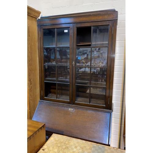 667 - A 1930's oak bureau bookcase with twin glazed doors over fall front and 3 drawers, cabriole legs (2 ... 