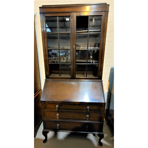 667 - A 1930's oak bureau bookcase with twin glazed doors over fall front and 3 drawers, cabriole legs (2 ... 